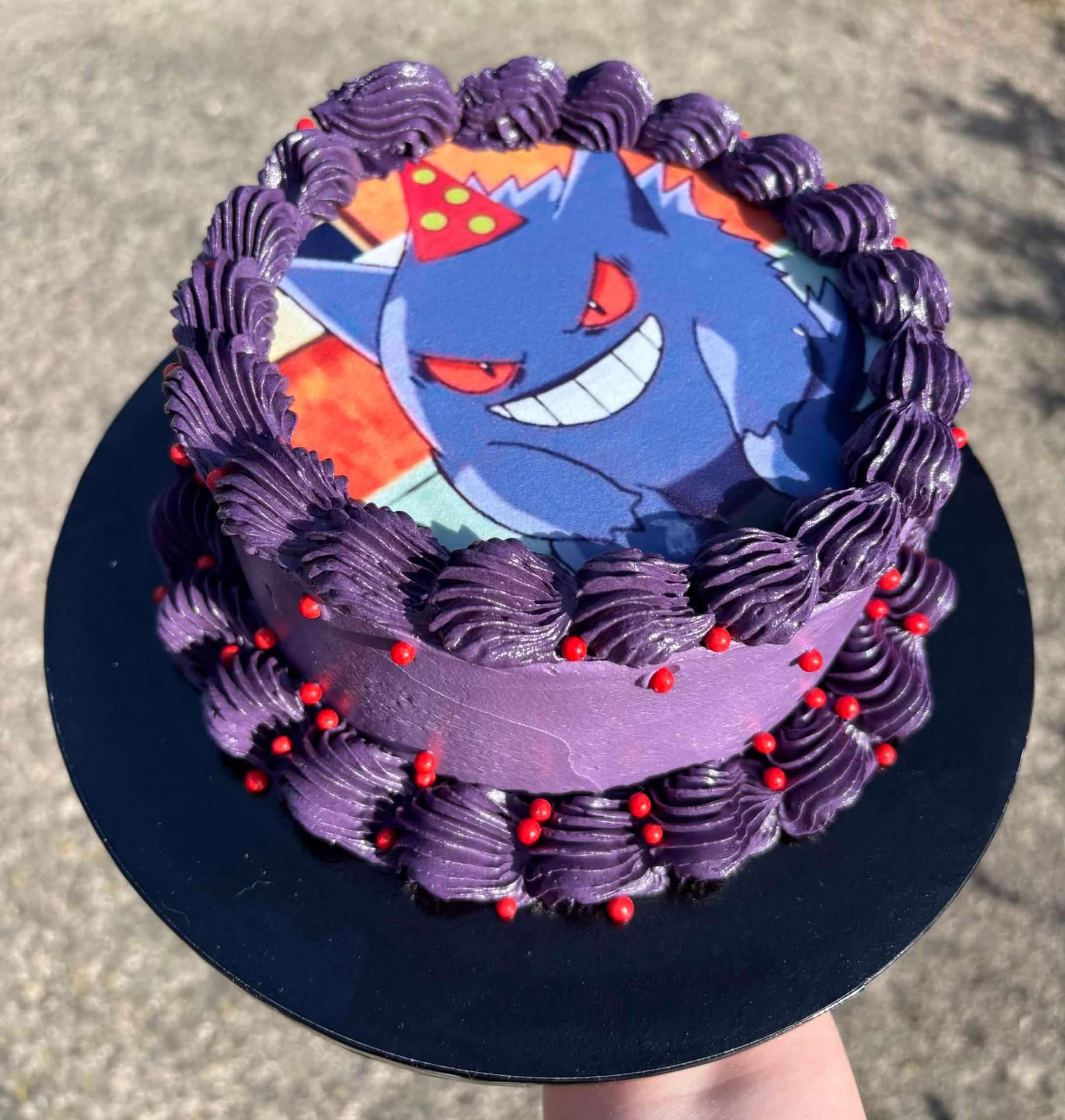 Purple buttercream birthday cake with a Gengar edible topper
