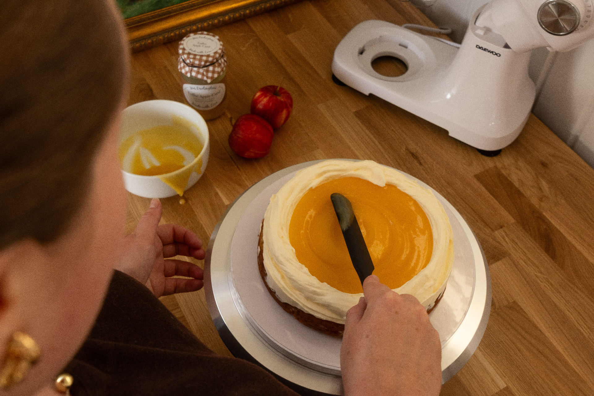 Spreading golden curd over a cake layer