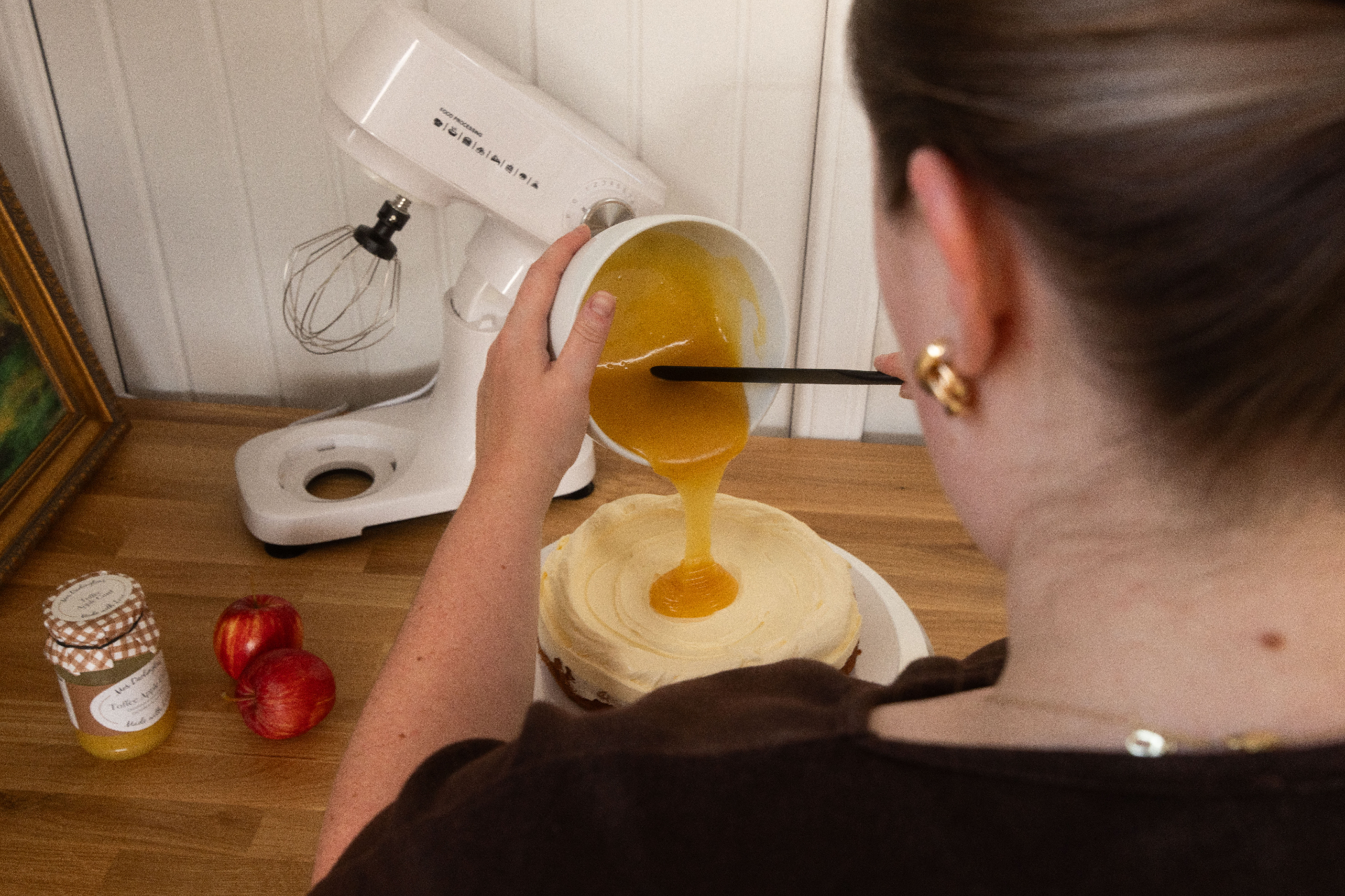 Pouring toffee apple curd onto buttercream