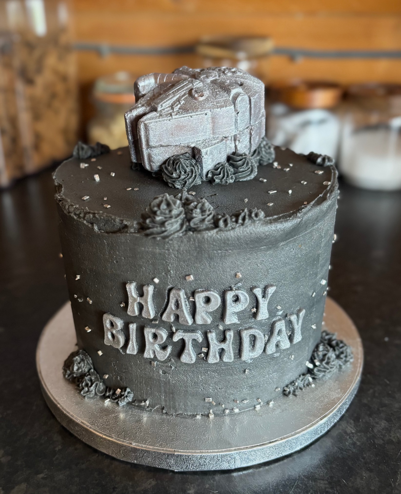 Black and silver Happy Birthday cake with edible topper