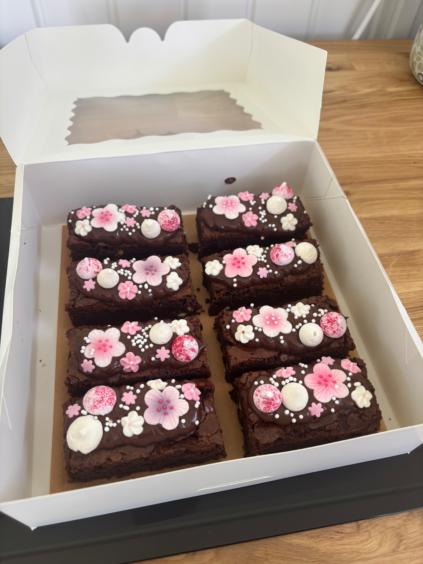 Boxed brownie slices topped with pink blossom decorations